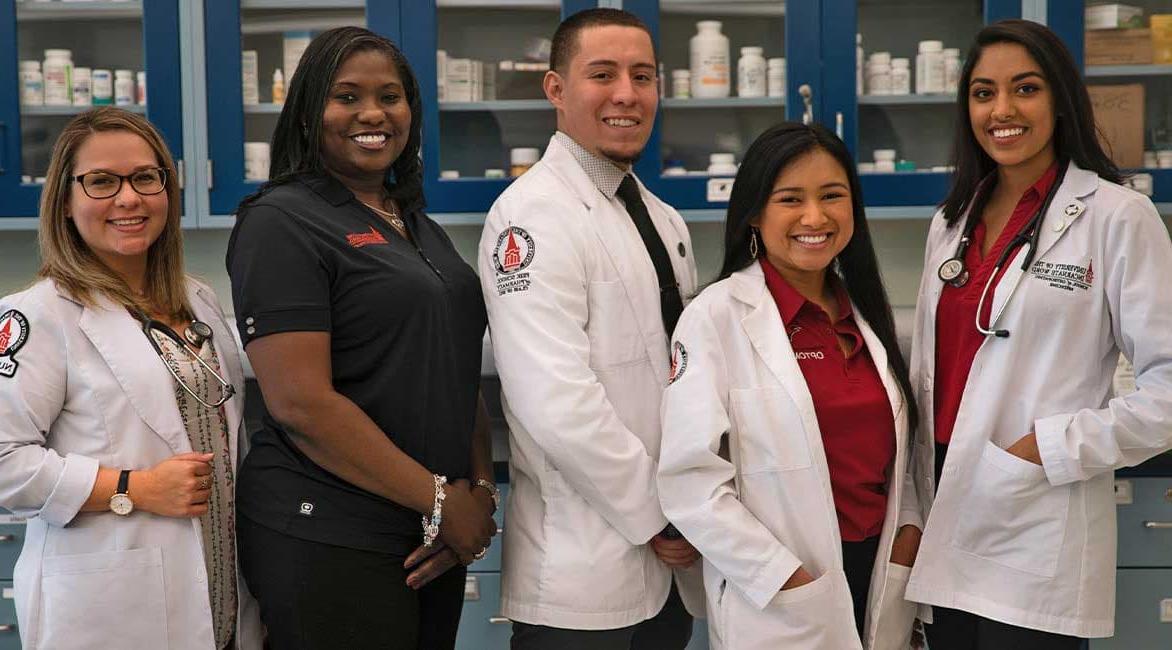 UIW health professions students smiling and standing for photo